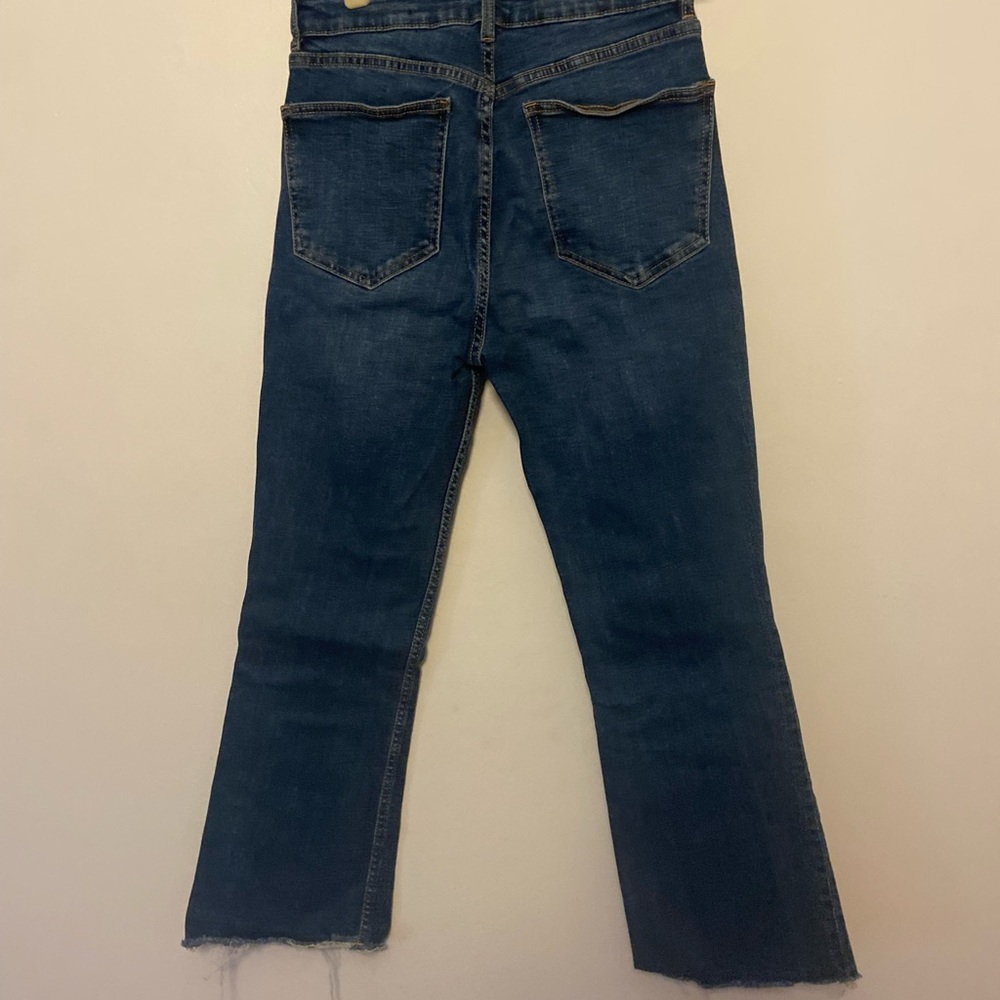 Zara slightly cropped, raw hem, slight flare jeans.